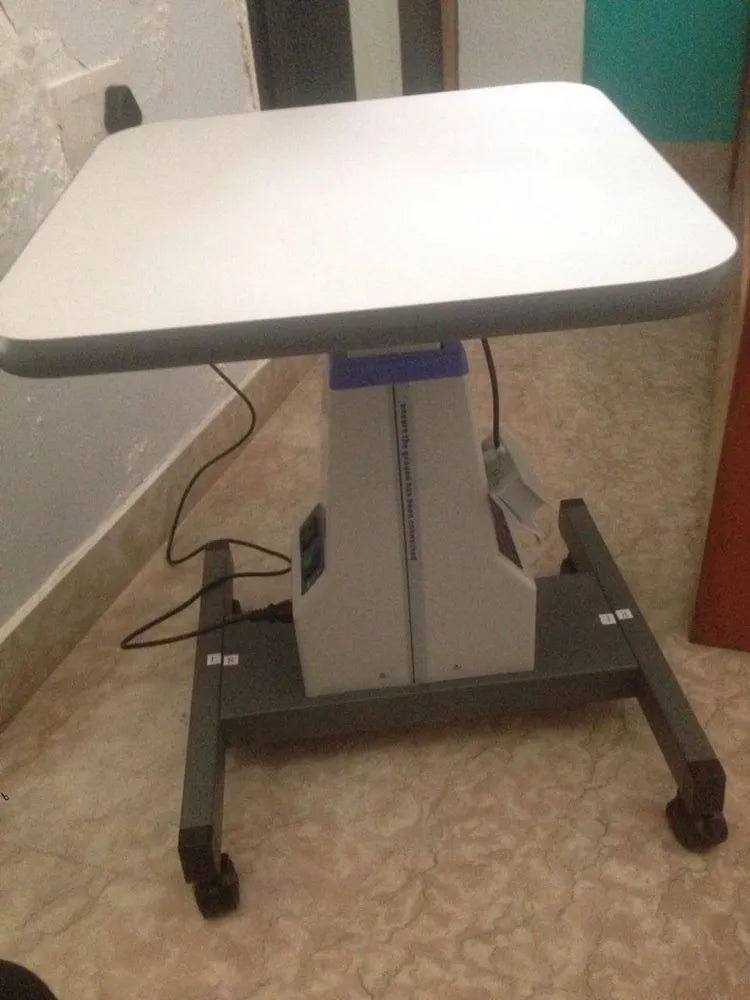 Ophthalmic exam table with silent motor and adjustable height